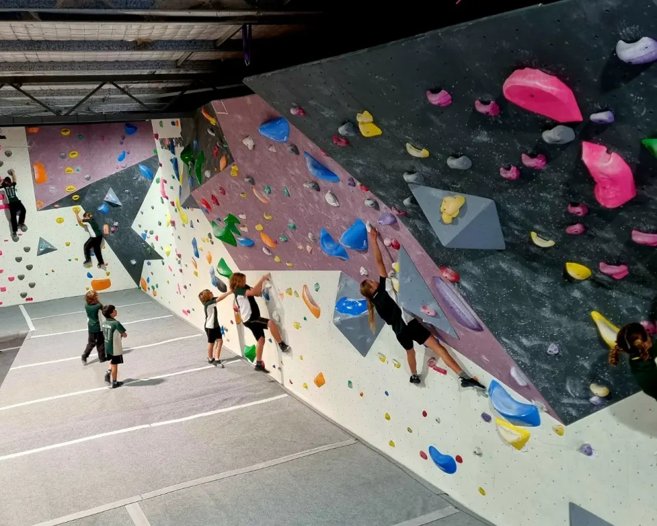 Climbers along the long bouldering wall
