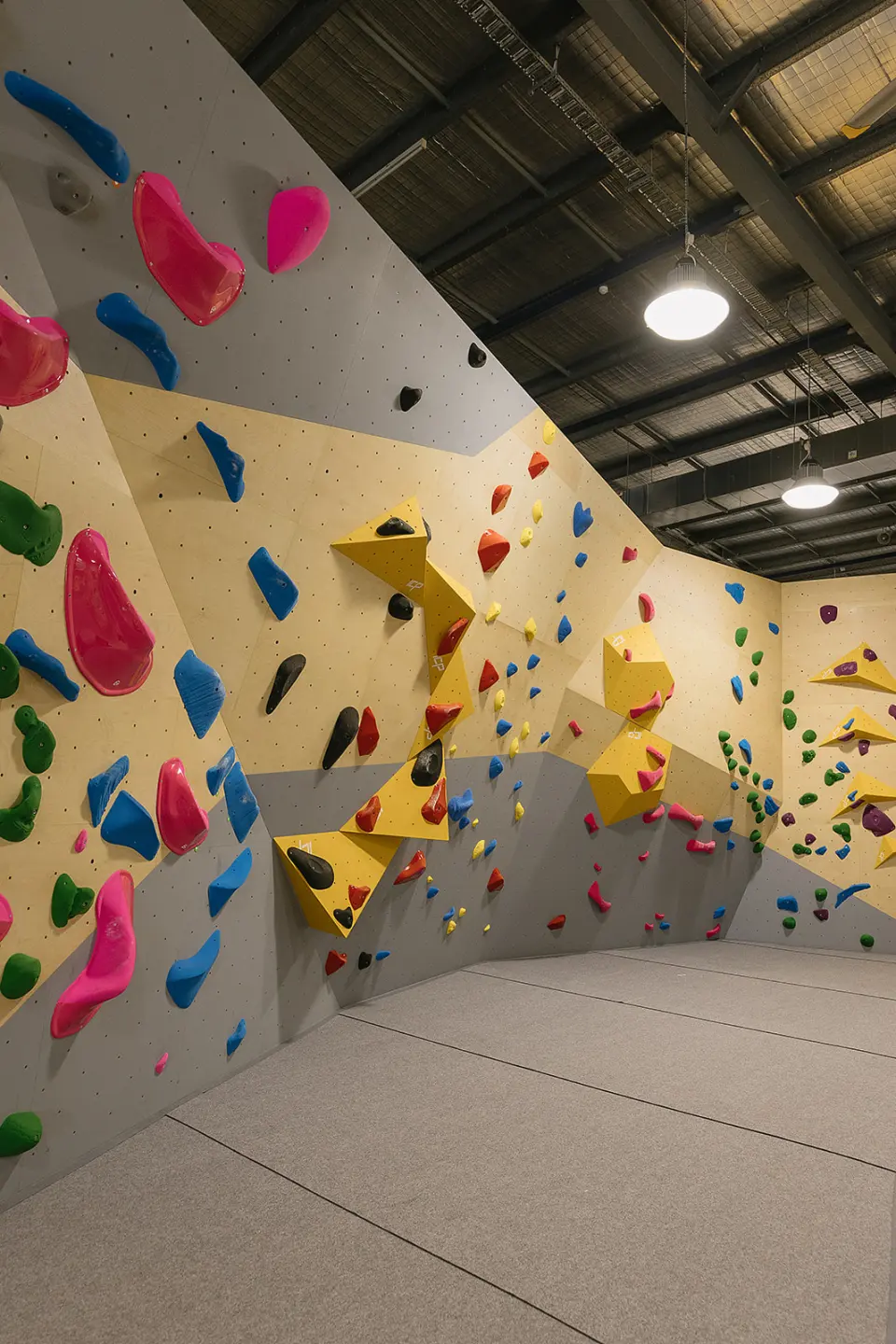 Corner of the bouldering area with pink and yellow holds