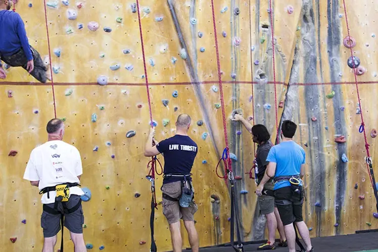 Belayers at the foot of the rope wall