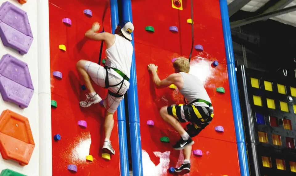 Two climbers side by side on the red walls