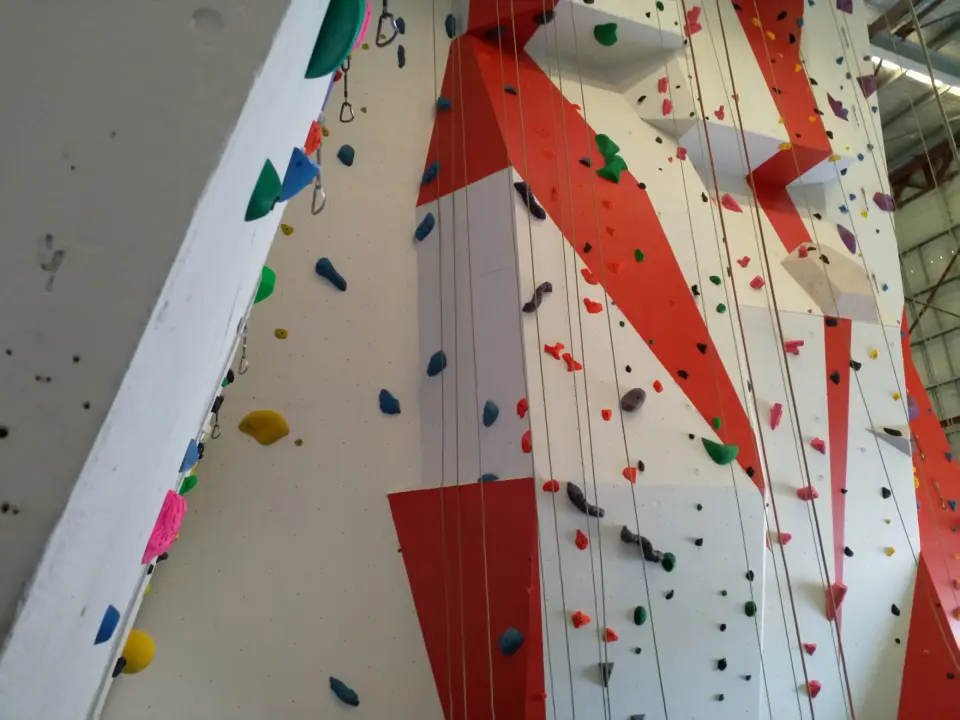 Top ropes hanging down the tall red and white wall at Vertical Reality Climbing in Holden Hill, Adelaide