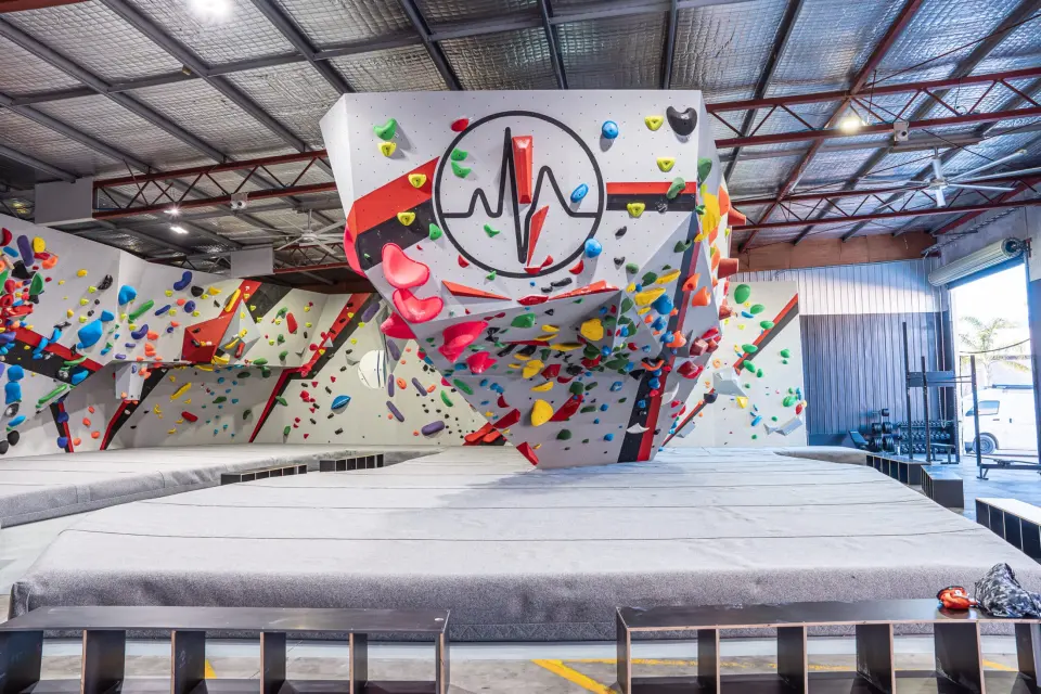 The bouldering hall at Pulse Climbing Adamstown in Newcastle, with its logo on the central boulder