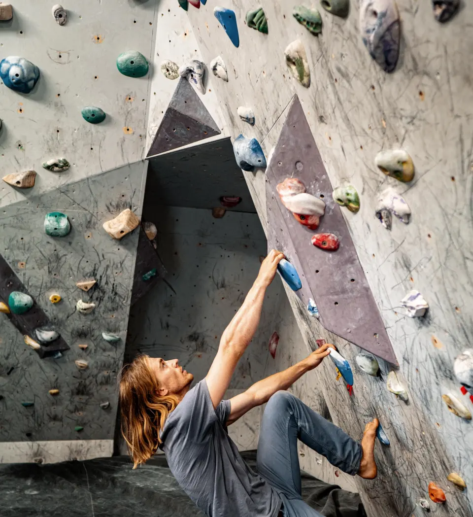Climber starting a problem under the overhang